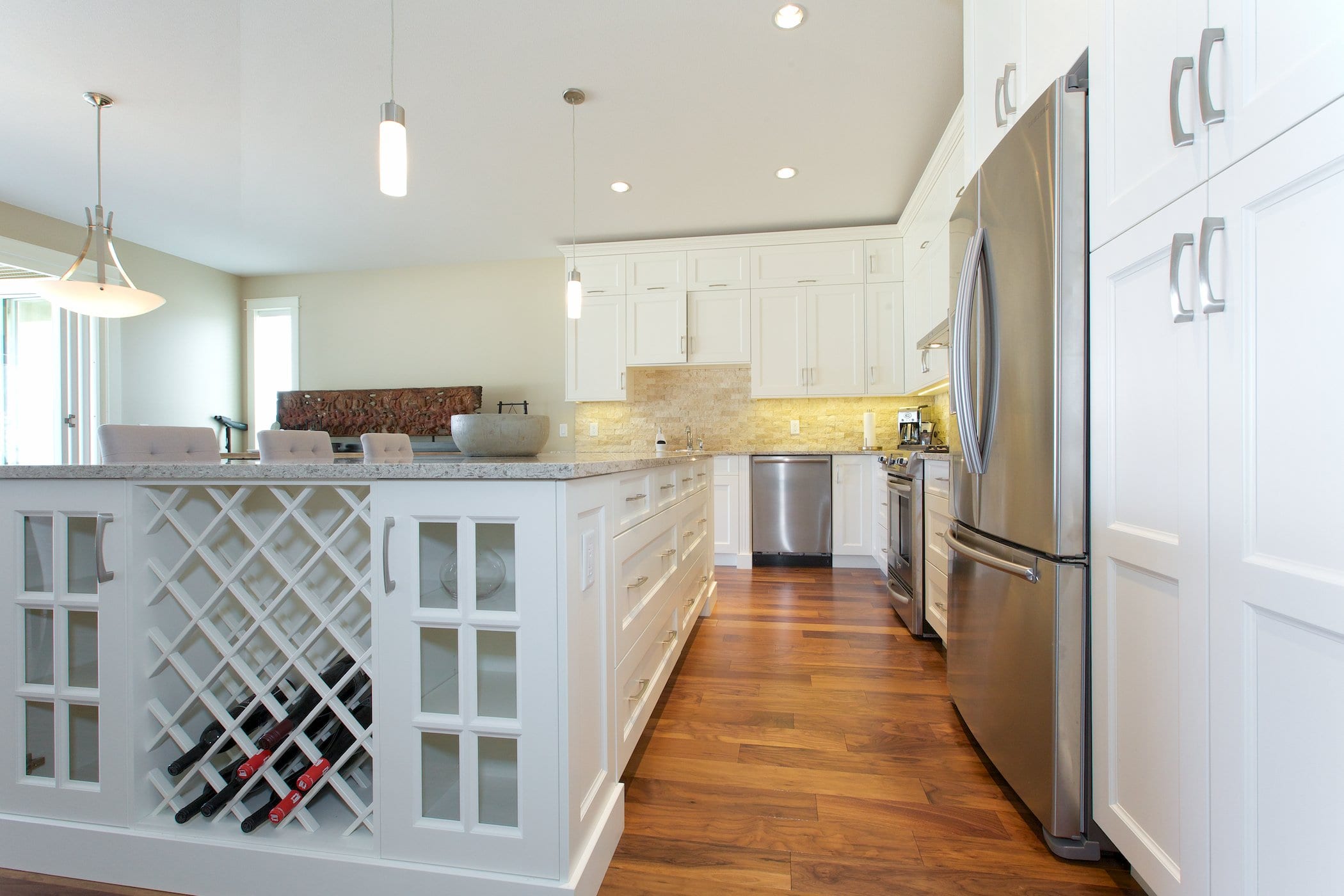 interior shot of west harbour home kitchen with white cabinetry fridge freezer stove and dishwasher