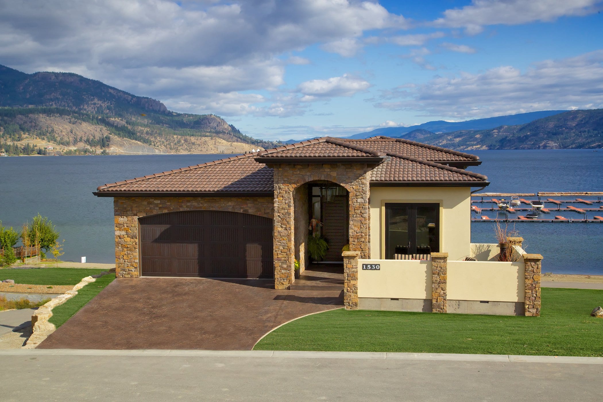 exterior shot of west harbour cream coloured house with lakeview of the okanagan