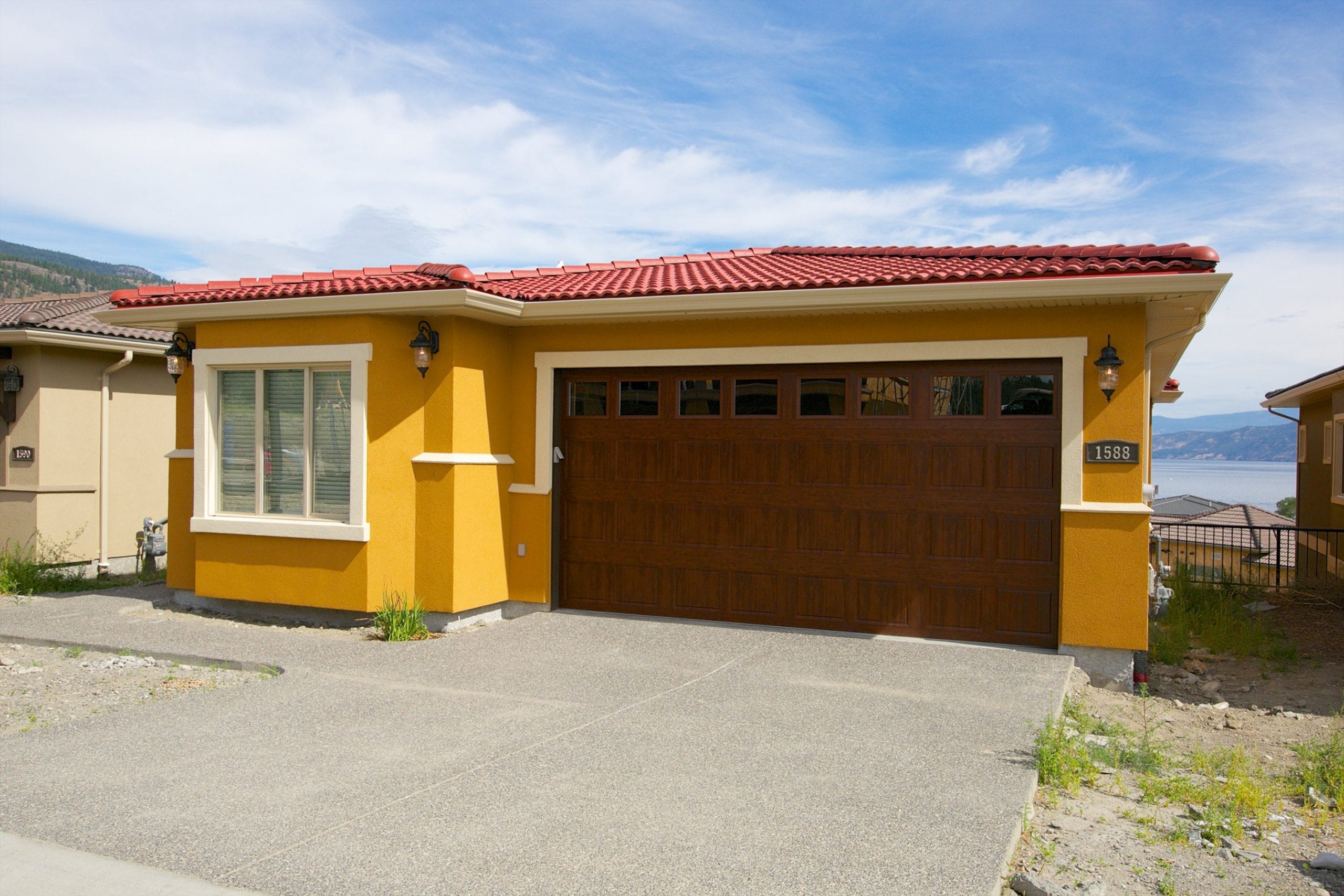 exterior shot of butterscotch coloured west harbour home with a red roof