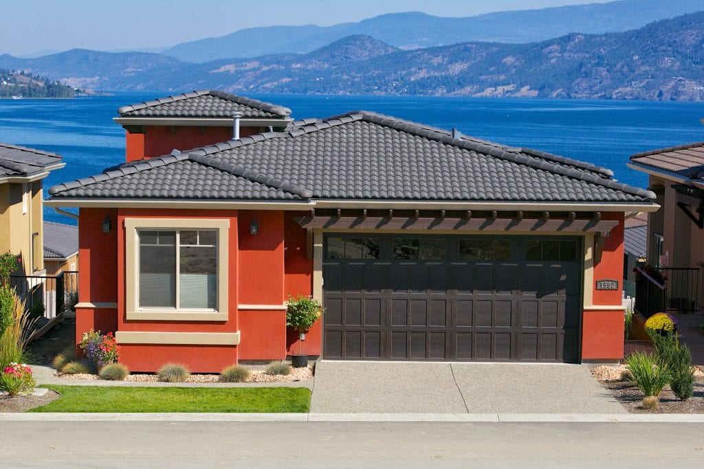 exterior shot of red chianti home with tan details in west harbour overlooking the lake in the background