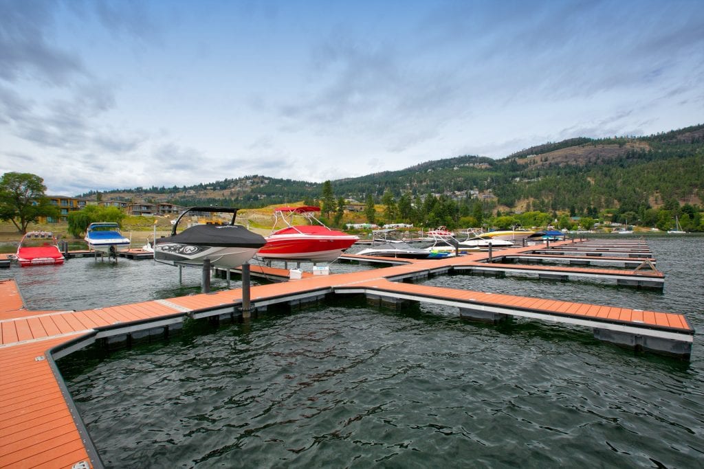 marina shot facing the mountains of red blue and black boats docked at west harbour marina amidst a cloudy day